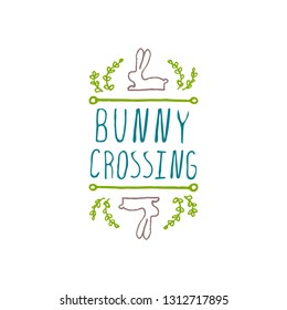 Hand drawn easter typographic element on white background. Bunny crossing. Suitable for print and web