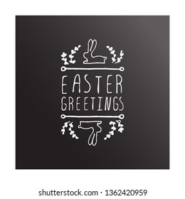 Hand drawn easter typographic element on chalkboard background. Easter Greetings. Suitable for print and web