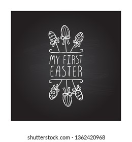 Hand drawn easter typographic element on chalkboard background. My first easter. Suitable for print and web