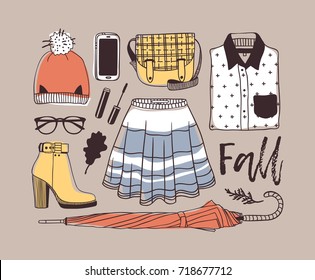 Hand drawn fall fashion illustration. Creative ink art work. Actual vector drawing. Autumn set: hat, phone, shirt, boot, glasses, skirt, umbrella, bag