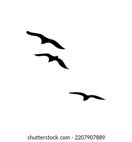 A Hand Drawn Flock of Flying Birds. Monochrome Bird Silhouettes. Illustration isolated on a white background. Vector