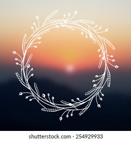 Hand drawn floral wreath with space to your text on blurred background