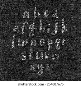 Hand drawn font on textured paper with paint strokes on black background