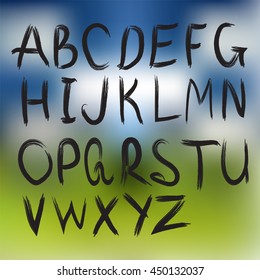 Hand drawn font,brush stroke alphabet on blur 