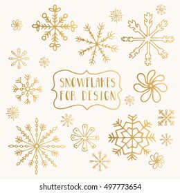 Hand drawn golden snowflakes isolated on background. Ink vector illustration.