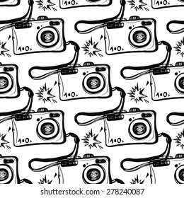 Hand drawn graphic black and white sketched camera and flash. Set of modern photo items seamless pattern. Hatched line art sketch on white background 