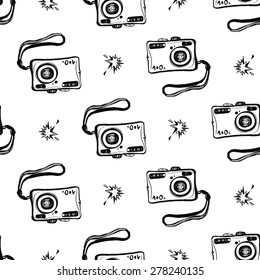 Hand drawn graphic black and white sketched camera and flash. Set of modern photo items seamless pattern. Hatched line art sketch on white background 