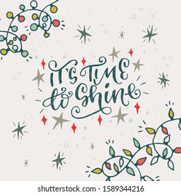 Hand drawn greeting card with lettering message It’s Time To Shine decorated with stars and twinkle lights. Curly calligraphic inscription of winter holiday mood decorated with multicolor garlands