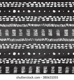 Hand drawn grunge black and white chalked seamless pattern with stripes, zigzag, paint daubs and dots on blackboard background.