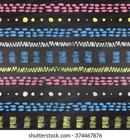 Hand drawn grunge color chalked seamless pattern with stripes, zigzag, paint daubs and dots on black chalkboard background.