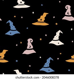 Hand drawn Halloween seamless vector pattern with witch hats and stars. Cute spooky background for Halloween party and autumn holidays. Trendy vector background. Flat style, kids illustration
