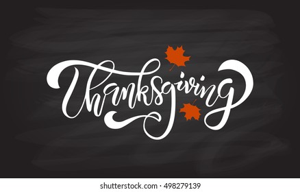 Hand drawn Happy Thanksgiving lettering typography poster. Celebration quotation on blackboard background for postcard, icon, logo or badge. White Vector vintage calligraphy text with red maple leaves