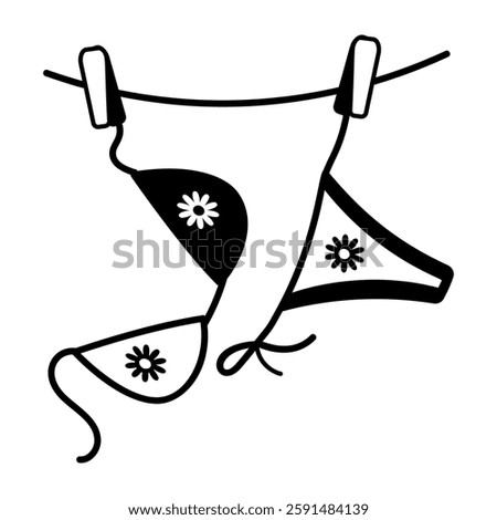 A hand drawn icon hanging bikini on clothesline 

