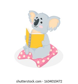 Hand drawn illustration of a cute little koala bear sitting on pink pillow and read a book in cartoons style. Vector illustration isolated on white background. Funny koala art - book lover
