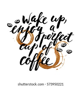 Hand drawn ink lettering with coffee beans, cup prints and stains. Wake up, enjoy a perfect cup of coffee.
