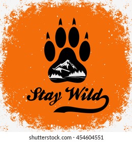 Hand drawn Inspiration Typography for t-shirt print. Stay wild. 
Travel, adventure poster with paw, mountain and forest. 