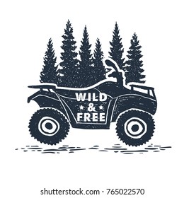 Hand drawn inspirational label with pine trees and quad bike textured vector illustrations and "Wild and free" lettering.