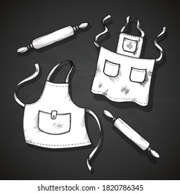 Hand drawn kitchen set. Vector illustration isolated on gray background. Collection of kitchen stuff: chef hat, aprons and rolling pins.