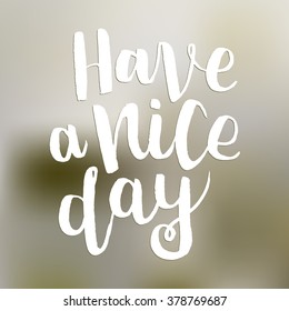 Hand drawn lettering "Have a nice day" white ink on blurred background. 