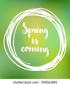 Hand drawn lettering Spring is coming on blurred background. 