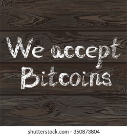 Hand drawn letters we accept bitcoins on wooden texure background