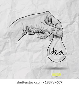 Hand drawn light bulb with IDEA word on crumpled paper as concept 