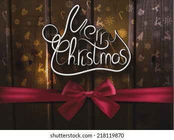 Hand drawn Merry Christmas on the wood background with silk ribbon
