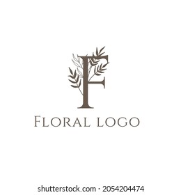 Hand drawn minimalist boho floral logo with tagline. Botanical logo template with foliage, wildflower, foliage, leaf, greenery, bloom, plant, herb. Trendy line art style flower clip art. Vector