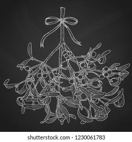 Hand drawn mistletoe branch. Vector romantic Christmas illustration. Winter holidays greeting card design. White chalk bouquet over black chalkboard.