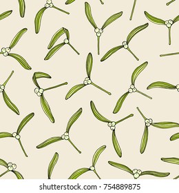Hand drawn mistletoe leaves seamless pattern. Vector Christmas illustration. Winter holidays greeting card design background over beige.