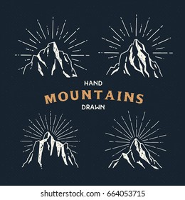 Hand Drawn mountains. Set of travel sketch illustration. Adventures logos isolated on dark background. Vintage trendy labels. Vector illustration.