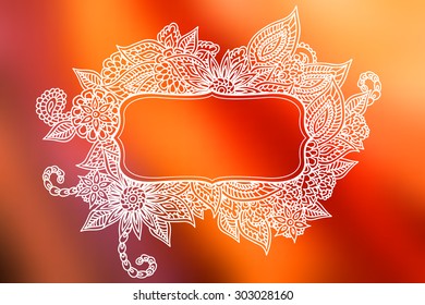 Hand drawn ornate doodle frame over abstract smooth blurry background.