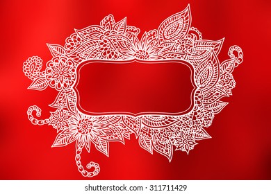 Hand drawn ornate doodle frame over abstract smooth blurry red background.
