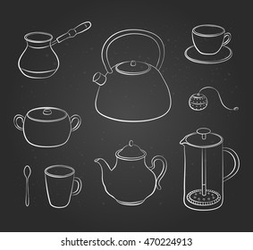 Hand drawn outline tea items and dishes isolated on the blackboard.
