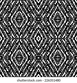 Hand drawn pattern with hand painted braids, brush strokes, ink marks, zigzag lines. Grunge vector seamless texture with ethnic and tribal motifs in black and white colors for fall winter fashion