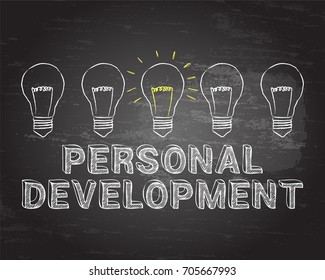 Hand drawn personal development sign and light bulb on blackboard
