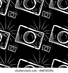 Hand drawn photo camera on chalkboard background. Vector seamless pattern.
