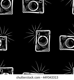 Hand drawn photo camera on chalkboard background. Vector seamless pattern.