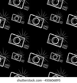 Hand drawn photo camera on chalkboard background. Vector seamless pattern.