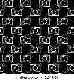 Hand drawn photo camera on chalkboard background. Vector seamless pattern.