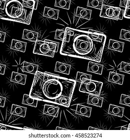 Hand drawn photo camera on chalkboard background. Vector seamless pattern.