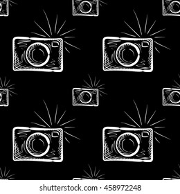 Hand drawn photo camera on chalkboard background. Vector seamless pattern.