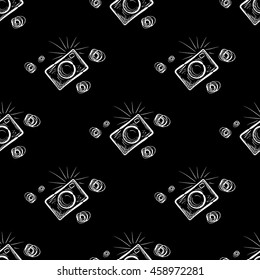 Hand drawn photo camera on chalkboard background. Vector seamless pattern.