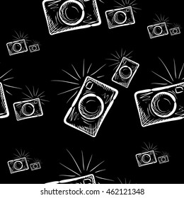 Hand drawn photo camera on chalkboard background. Vector seamless pattern.