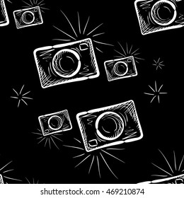 Hand drawn photo camera on chalkboard background. Vector seamless pattern.