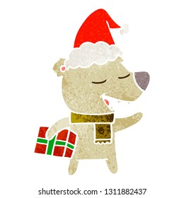 hand drawn retro cartoon of a bear with present wearing santa hat