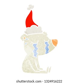 hand drawn retro cartoon of a crying sitting polar bear wearing santa hat