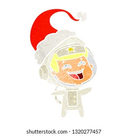 hand drawn retro cartoon of a laughing astronaut wearing santa hat