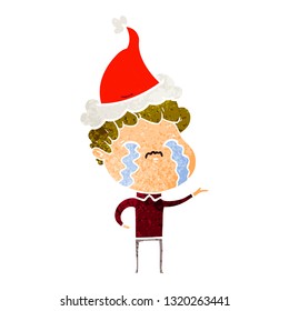 hand drawn retro cartoon of a man crying wearing santa hat