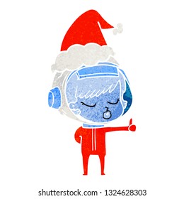 hand drawn retro cartoon of a pretty astronaut girl giving thumbs up wearing santa hat